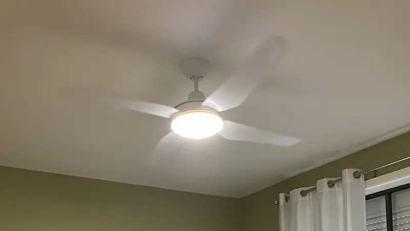 White ceiling fan with a built-in light in a bedroom